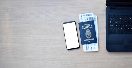 Argentine passport and boarding pass with smartphone with copy space on wooden table