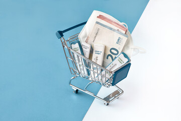 Cost of shnelltest, rapid corona test in German language. Shopping cart with covid 19 antigen tests and money. Mismanagement, embezzlement in rapid COVID testing centers, wasting taxpayers' money.