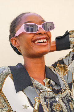 Girl on sunglasses laughing.