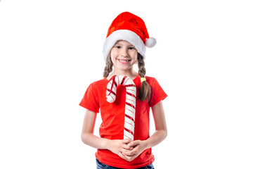 Christmas portrait of cute little girl wearing a santa hat and holding cane isolated on white background