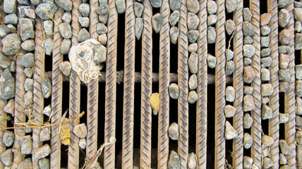 Rebar grate with stones on the ground
