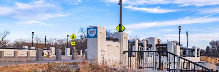 Concrete bridge with signs and streetlights panorama