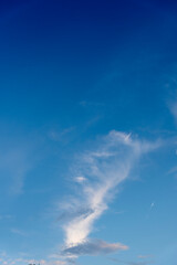 Fototapeta na wymiar Blue sky background and white clouds soft focus with empty space. Portrait size.