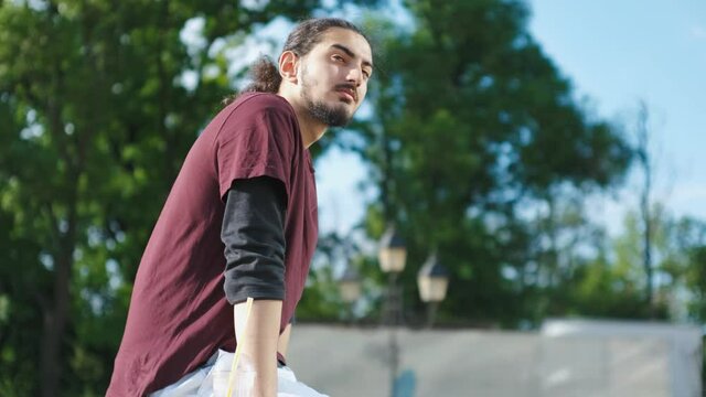 Close-up portrait of handsome Arab man sitting in the park