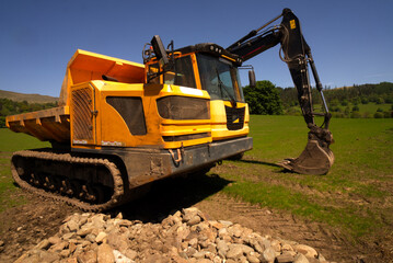 Excavators are heavy construction equipment consisting of a boom, dipper, bucket and cab on a rotating platform known as the "house". The house sits atop an undercarriage with tracks or wheels