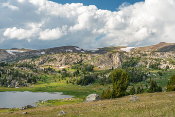 Fototapeta premium Beautiful late day sunlight and clouds Beartooth Scenic Byway at Long Lake in Wyoming