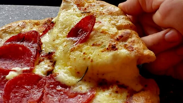 close up of a slice of pizza pull