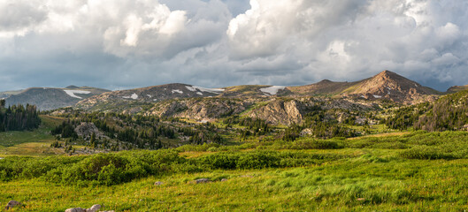 Fototapeta premium Beautiful late day sunlight and clouds Beartooth Scenic Byway near Long Lake in Wyoming