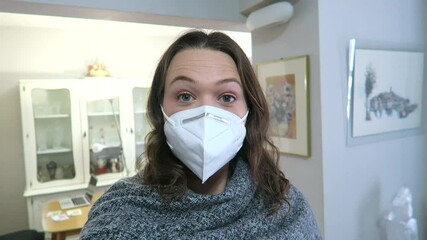 Attractive woman vlogging at home, wearing a face mask - Powered by Adobe