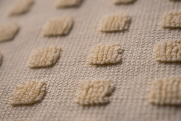 Close up of some yellow woven squares with wool texture 