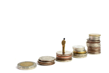 Miniature figures businessman stand on coins, on the white backgroud.