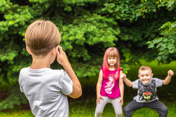 brothers and sister are photographed in the meadow