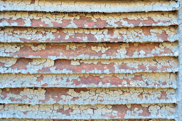 Rusty metal grilles, painted with paint and peeled off from old age, ventilation holes for air ingress in industrial facilities