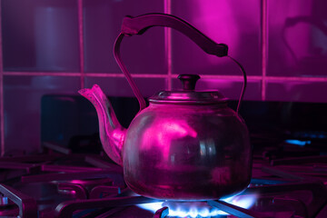 kettle warming up on the stove, with neon lights