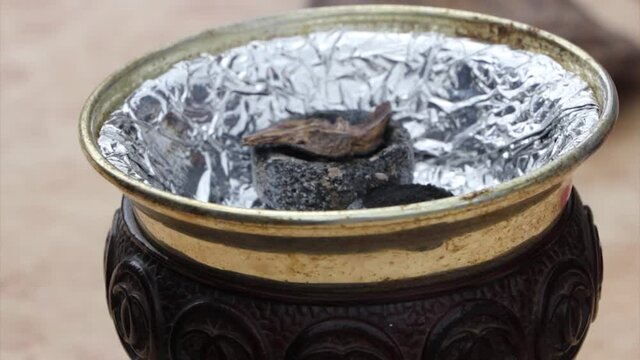 Burning incense. piece of agarwood placed on top of burning charcoal, Nepal
