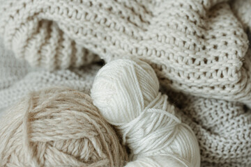 Cozy composition with knitted yarn in pastel colors.