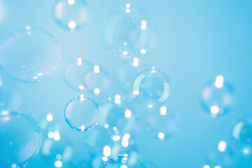 Beautiful Transparent Soap Bubbles Float on Blue Background.