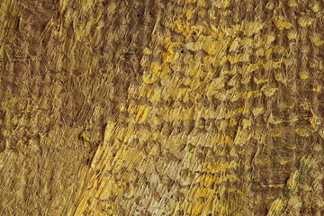 Texture of artistic oil strokes of paint on canvas, monochrome yellow-brown colors, abstract background