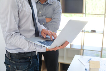 Sales manager giving advice application form document, considering mortgage loan offer for car and house insurance.