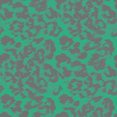 Seamless leopard spotted pattern. Dark gray spots on a green background.