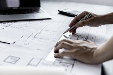 Architect engineers are writing house plans in order to modify some of the designs according to the needs of the customers after the proposals are requested to modify the drawings. Interior Design.