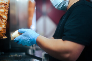 Restaurant Cook Putting Chicken Meat in Pita Wrap Making a Traditional Dish