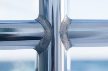 Welding joint of aluminum tubes close-up.