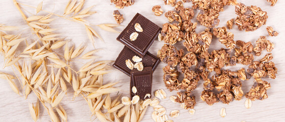 Ears of oat, flakes, granola and chocolate containing iron and fiber, healthy snack concept