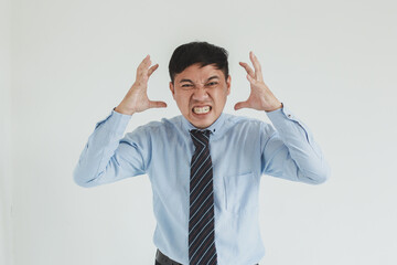 Frustrated sales man wearing blue shirt and tie posing with angry face looking at camera on white background
