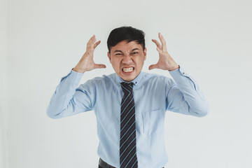 Frustrated sales man wearing blue shirt and tie posing with angry face looking at camera on white...