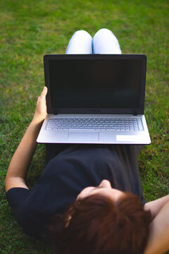 Girl on the grass with a laptop