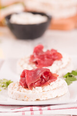 Rice cakes with milk flakes and cold beef.