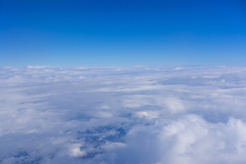 Top view from fly, aerial view of clouds in blue sky