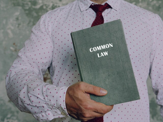 Book with title COMMON LAW . Common law is a body of unwritten laws based on legal precedents...
