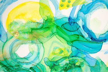 Abstract ink blue, green and yellow watercolor ink drops background. Alcohol ink illustration.