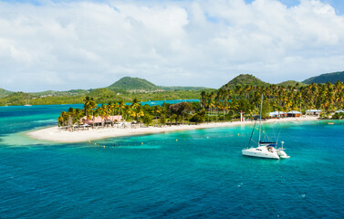 The coast of the island of Martinique in the Caribbean. Yachts, palm trees, beaches and turquoise...