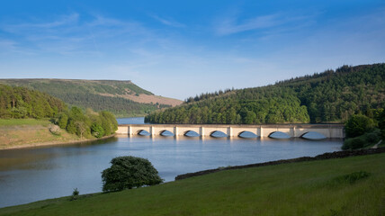 Peak District, Derbyshire, UK, The Snake Pass goes over the Ladybower reservoir on the Ashopton viaduct with Bamford Edge in the backround