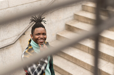 Black man on a stairs in the city.