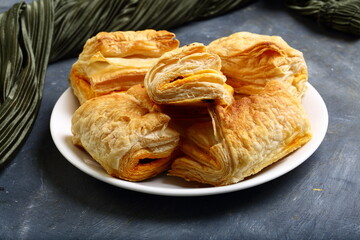 Oven fresh crispy baked mutton curry puffs , homemade recipes background.