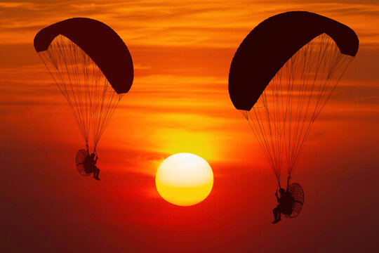 silhouette paramotor at sunset