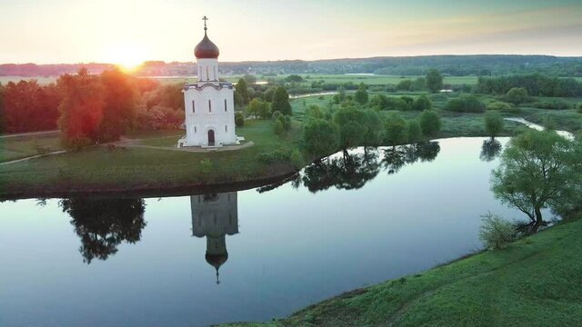 Church of the Intercession on the Nerl in Bogolyubovo, Russia. Famous landmark of the Golden Ring of Russia. Aerial drone view. Beautiful summer landscape at sunrise. 