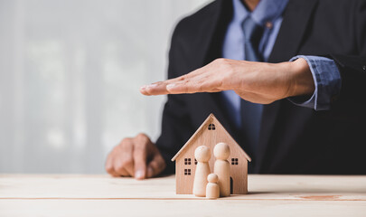 Insurance house, and family health live concept. The insurance agent presents the ้hands...