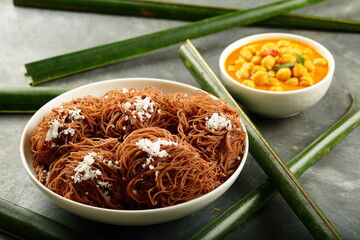 Healthy red rice idiyappam - steamed string hoppers served with chickpea curry - Kerala cuisine.