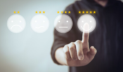 Customer review good rating concept hand pressing smile face icon on visual screen and positive customer feedback testimonial	