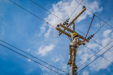 The power lineman use clamp stick (insulated tool) to closing a transformer on energized...