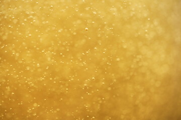 Close up motion blur texture of beer bubbles