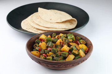 aloo bhindi or okra and potato side dish eaten with roti or chappati also called as Indian flat bread