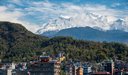 Pokhara cityscape with the Annapurna mountain range covered in snow at central Nepal, Asia