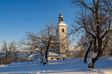 Fototapeta na wymiar Gora or Malenski vrh mountain with church in Slovenia in winter