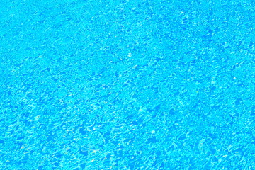 Top view of beautiful swimming pool with clear water and sunlight reflection on the surface in bright blue tone